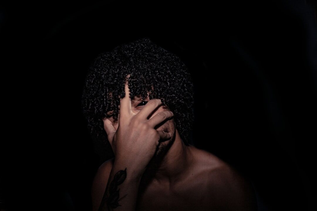 Studio portrait of a young Brazilian man with curly hair